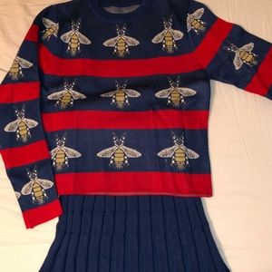 Blue sweater with bees and blue ribbed knit skirt